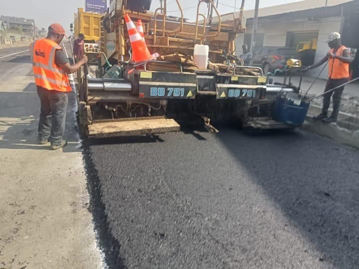 Asphalt paver laying fresh asphalt mat