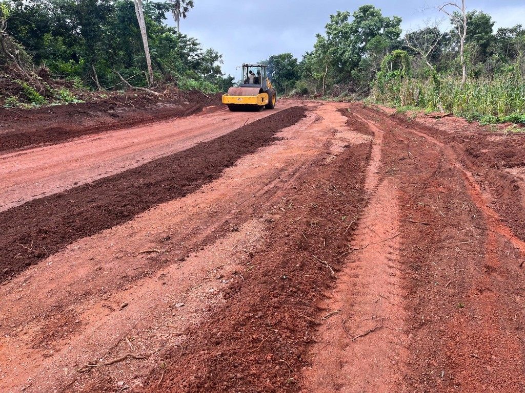 Yellow roller compacting laterite road corridor