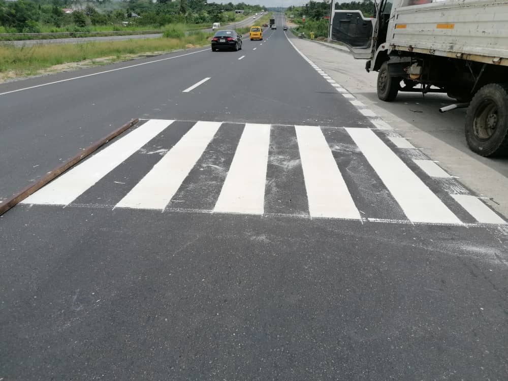 Freshly painted zebra crossing on asphalt highway